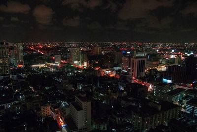 High angle view of illuminated city buildings at night