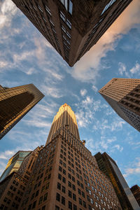 Low angle view of modern buildings against blue sky in city