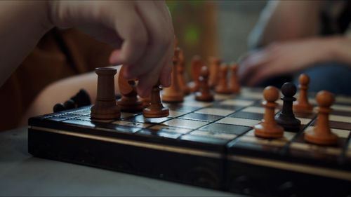 Midsection of man playing chess