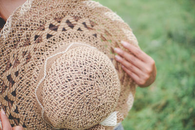 Close-up of woman holding hat
