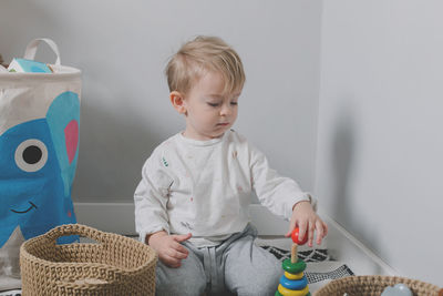 Portrait of cute baby boy holding teddy bear