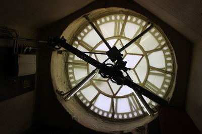 Close-up of clock against wall in building