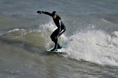 Full length of man surfing in sea