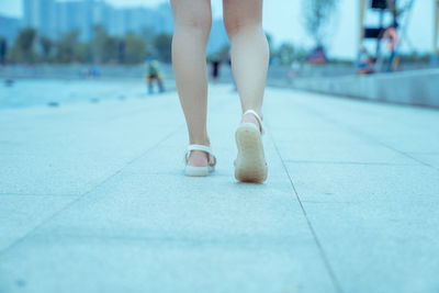 A girl is walking on her feet