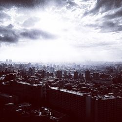 High angle view of city buildings against sky