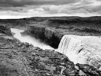 Scenic view of waterfall against sky