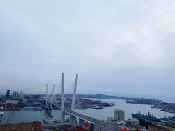 High angle view of bay and buildings against sky