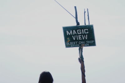 Low angle view of information sign against sky