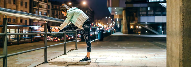 Low angle view of woman walking on street
