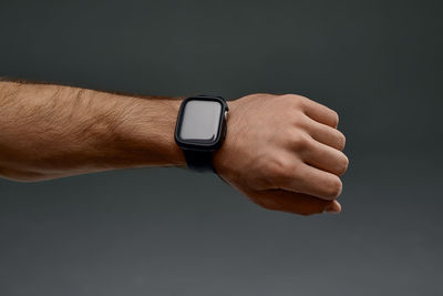 Cropped hand of man gesturing against white background