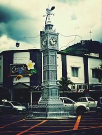 Low angle view of building against cloudy sky