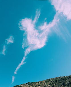 Low angle view of vapor trail against blue sky