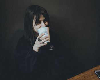Portrait of a woman drinking coffee
