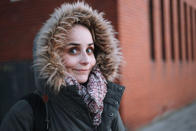 Portrait of beautiful young woman in warm clothing during winter