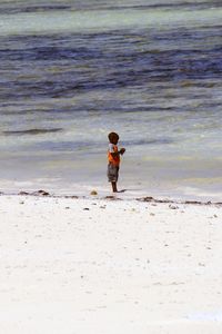 Full length of woman standing on beach