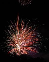 Low angle view of firework display at night