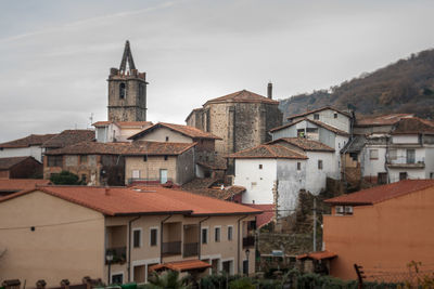 Buildings in city against sky