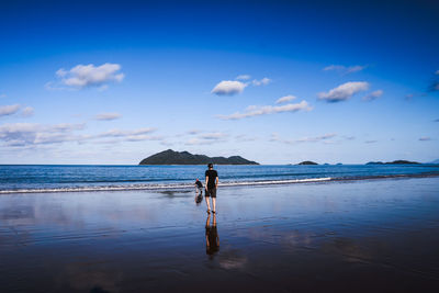 Man standing on beach against sky