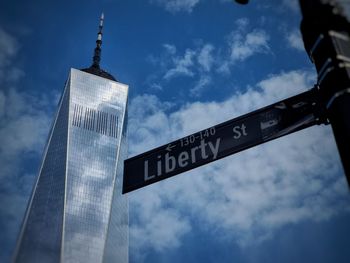 Low angle view of road sign against one wtc