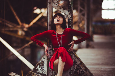 Portrait of young woman in red dress