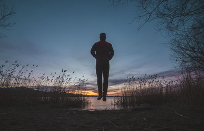 Silhouette of woman standing in water