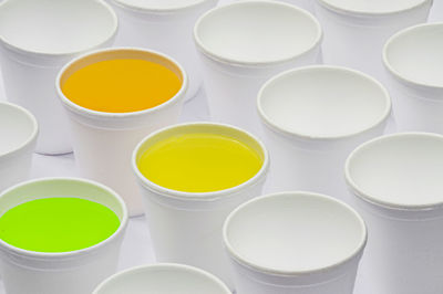 High angle view of paints in disposable containers