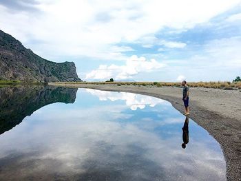 Scenic view of lake against cloudy sky