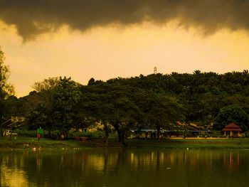 Scenic view of lake against sky at sunset