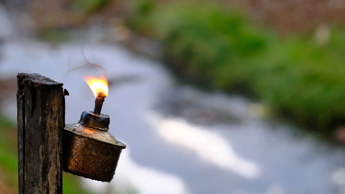 Close-up of burning candles on wood
