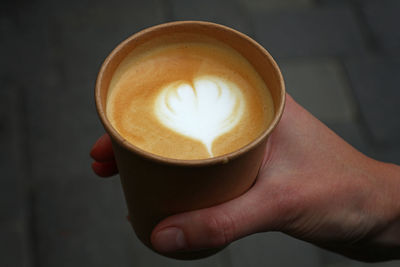 Close-up of person hand holding coffee cup