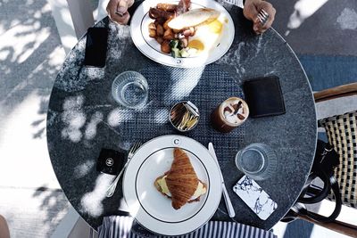 Directly above view of man eating brunch at sidewalk cafe