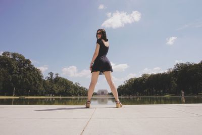 Full length of woman against trees against sky