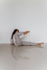 Rear view of woman standing against white background