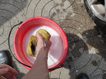 High angle view of man holding sponge