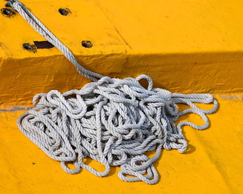 High angle view of rope on yellow pier