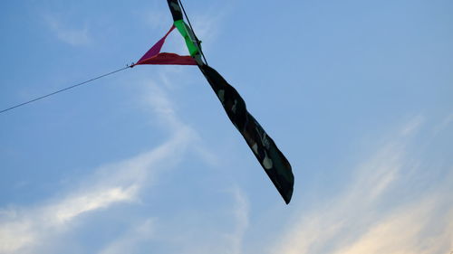 Low angle view of flags hanging against sky