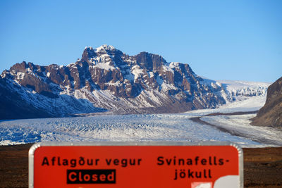 Scenic view of snowcapped mountains against clear blue sky