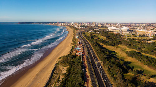 High angle view of sea and buildings against sky