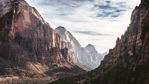 Scenic view of rocky mountains against cloudy sky