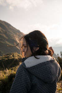 Young woman portrait in the mountains with sunlight