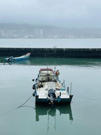 Boats in sea against sky