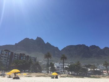 Rear view of landscape against clear blue sky