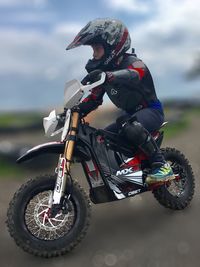 Low angle view of man riding motorcycle