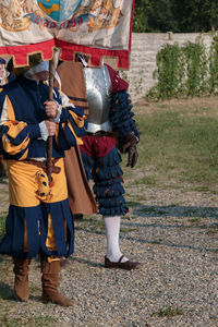 People in traditional clothing standing on street