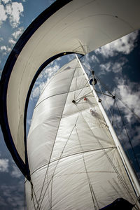 Low angle view of ship sailing on sea against sky