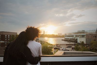 Rear view of couple standing against sky