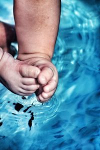 Close-up of feet in swimming pool