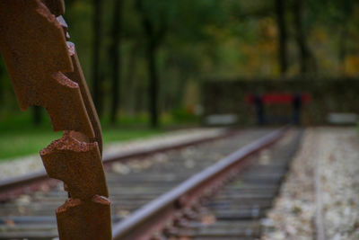 Close-up of rusty metal by railroad track