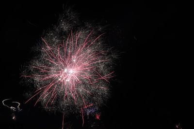 Low angle view of firework display at night