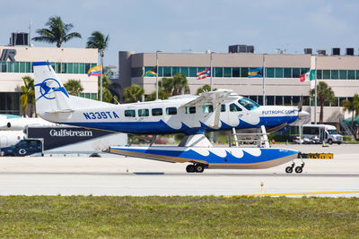 Airplane on airport runway against sky